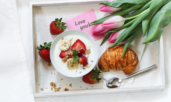 Breakfast in bed for Valentines with strawberries and tulips