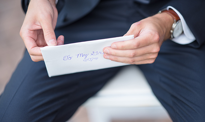 Man holding an envelope clue